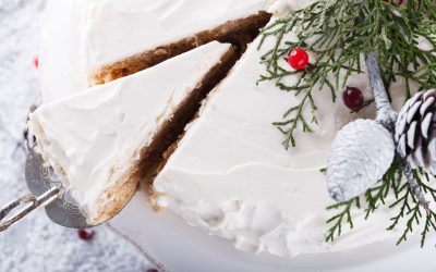 Cake with white cream,garnished with sprigs of spruce ,pine cones,cranberries.